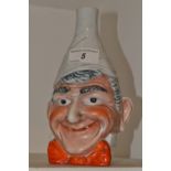 A Saxe Novelty mask vase, in relief with a comical man, wearing a red bow tie,