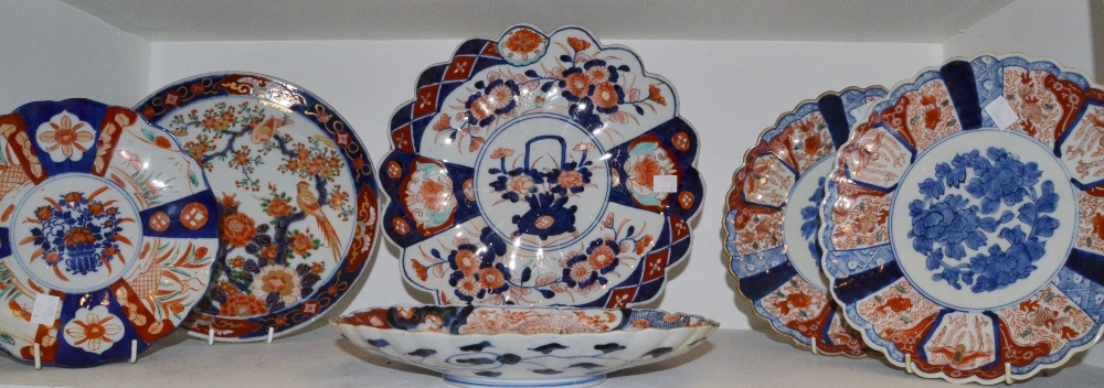 A pair of Japanese Imari shaped circular plates, decorated in the typical palette,