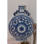 A Chinese blue and white moon flask, decorated with lotus leaf panels each with precious objects,