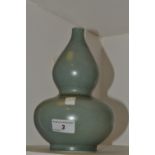 A Chinese monochrome double gourd vase, in a mottled green glaze, 23.