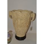 An Oriental carved resin vase, elephant mask handles,