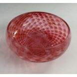 An Art Deco British pink glass bowl, with swirls of cream and bubble inclusions,