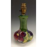 A Moorcroft Anemone pottery table lamp, tubelined pink and purple flowers on a green ground,
