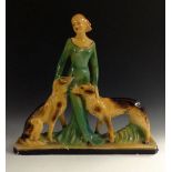 An Art Deco plaster figure, of a young woman in an evening gown flanked by two dogs, 52cm high, c.