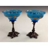A pair of 19th century EPNS mounted pedestal sweetmeat baskets, the opaque blue glass bowls,