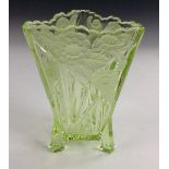 A Sowerby green uranium pressed glass triform vase, moulded with flowering foliage,