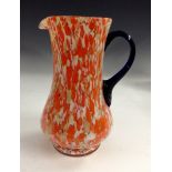 A Czechoslovakian Art Deco splatter glass jug, in tones of orange, white and green,