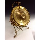 An Arts and Crafts brass coal scuttle, hinged cover, embossed with a flowerhead,