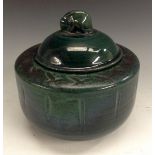 A Royal Doulton Chang type ribbed cylindrical tobacco jar, glazed throughout in dark jade green, the