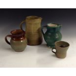 A Janet Leach brown glazed pottery mug, flared rim, impressed potter mark, 8.