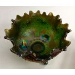 An American Fenton green Carnival glass Orange Tree bowl, three scroll feet, crimpled rim,