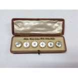 A set of six 9ct gold and mother of pearl gentleman's dress studs,