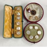 A set of six gentleman's dress studs, mother of pearl roundels encased in yellow metal,