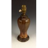 A French Art Nouveau inverted baluster lamp base, in mottled tones of brown and orange,