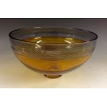 A Bob Crooks Art Glass circular amber bowl, with fine black threading to rim,