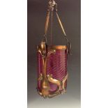 An Art Nouveau copper and cranberry ceiling light, the framed with sinuous scrolls,