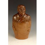 A Doulton Lambeth salt glazed stoneware spirit flask modelled as John Burns,