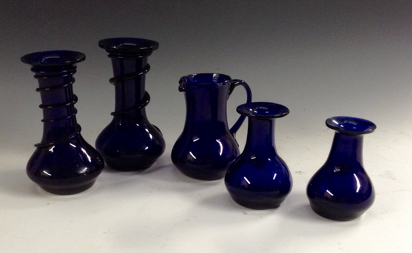 A pair of Bristol Blue glass vases, applied with spiral trails, flared rim,