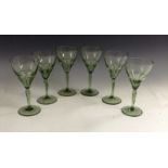 A set of six Keith Murray for Stevens and Williams olive green wine glasses, panel cut bowls,