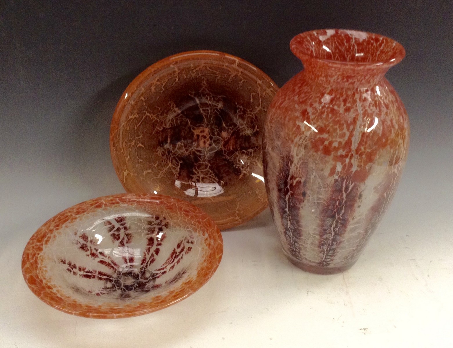 A WMF Ikora crystal glass ovoid vase, decorated with red, puce and clear crackle effect specks,