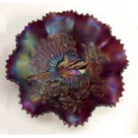 An American Northwood amethyst Carnival glass crimpled dish, Peacocks on the fence pattern,