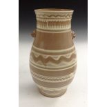 A Japanese baluster vase, decorated with Dog of Fo handles on a brown ground,