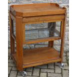 An Art Deco walnut canted rectangular two-tier tea trolley, the top with removable tray,