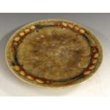 An Art Deco Cranstone Woods plate, the rim decorated with tubelined shapes,