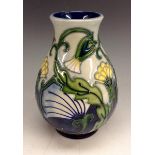 A modern Moorcroft pottery baluster vase, tubelined with yellow flowers on a graduated blue ground,