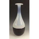 An Ian Bamford art glass black and white slender incalmo bottle vase, signed Ian Bamford to base,