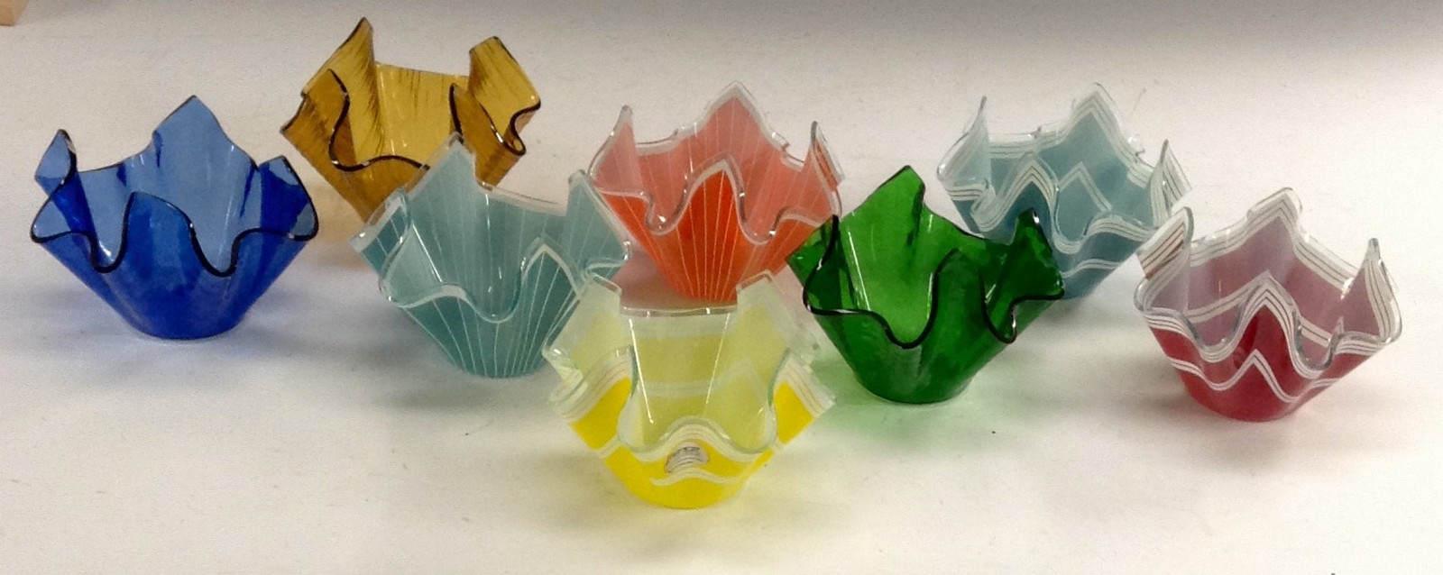 A harlequin set of eight Chance glass handkerchief bowls, including the patterns Bandel, Cordon,