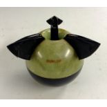A Dunlop bakelite ashtray, in the form of a tennis ball, in black and marbled green,