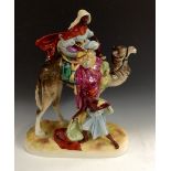 A large Victorian Royal Dux figural group, of a camel, rider and attendant, painted in gloss finish,
