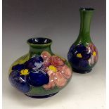 A Moorcroft Anemone squat vase, tubelined pink and purple flowers on a green ground,