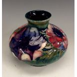 A Moorcroft compressed ovoid Anemone pattern vase, typically tube lined with colourful flowers, 8cm,