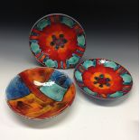 A pair of Poole pottery circular bowls, brightly decorated with orange, red,