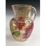 An iridised crackle glass jug, decorated with enamel corals and sea fan, applied clear glass handle,