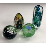 An Isle of Wight studio glass paperweight, with swirls of blue and green, flecks of white,