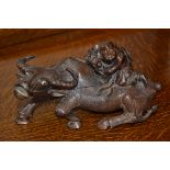 A Chinese hardwood carving of a boy astride a buffalo, boldly carved,