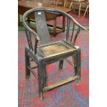 A Chinese hardwood elbow chair, hooped top rail, splat with carved stylized dragon panel,