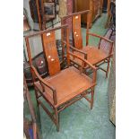 A pair of oriental hardwood armchairs, S-form splat, shaped open arms, panel seat,