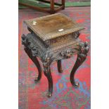 A Chinese style hardwood plant stand, square top with Greek key border, floral carved frieze,