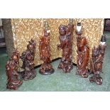 A set of four Japanese carved rootwood table lamps as elders and deities;