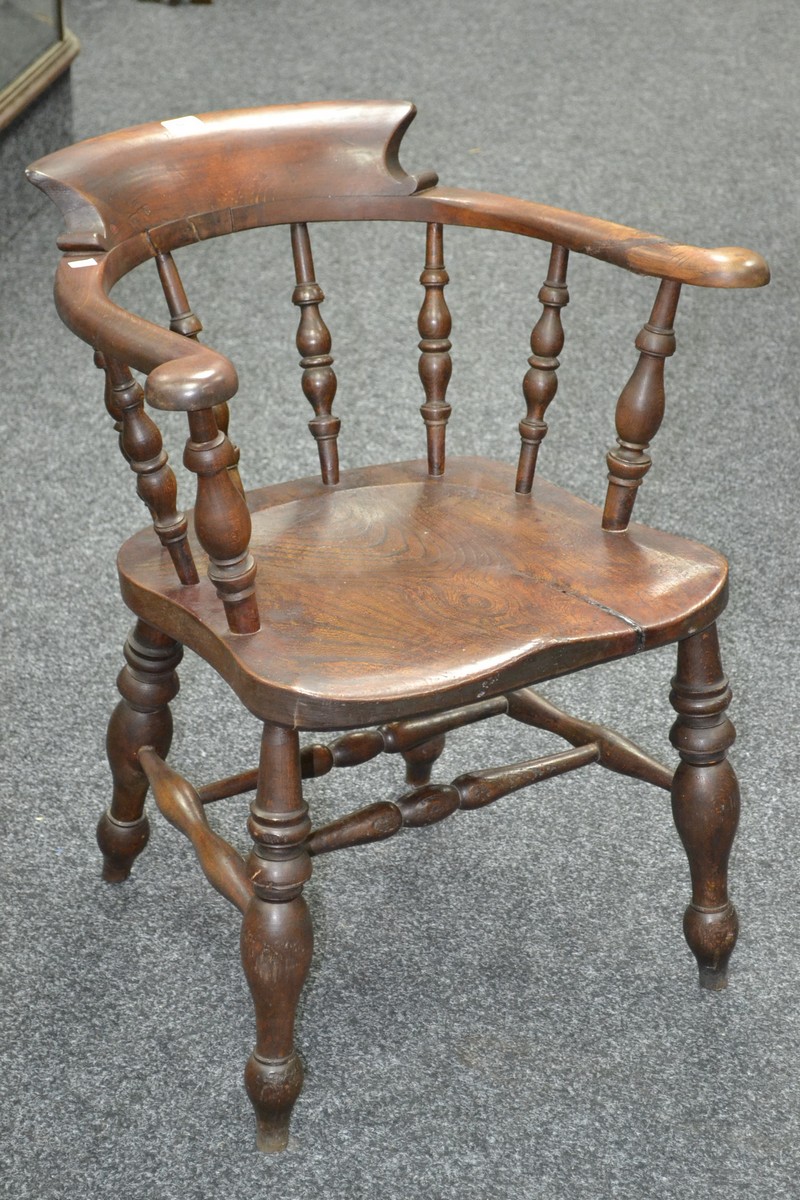 A late 19th century elm smoker's bow chair, stamped with LNWR to seat,