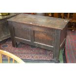 A 19th century oak coffer, plank top, strapwork hinges, candle box to interior, two panels to front,