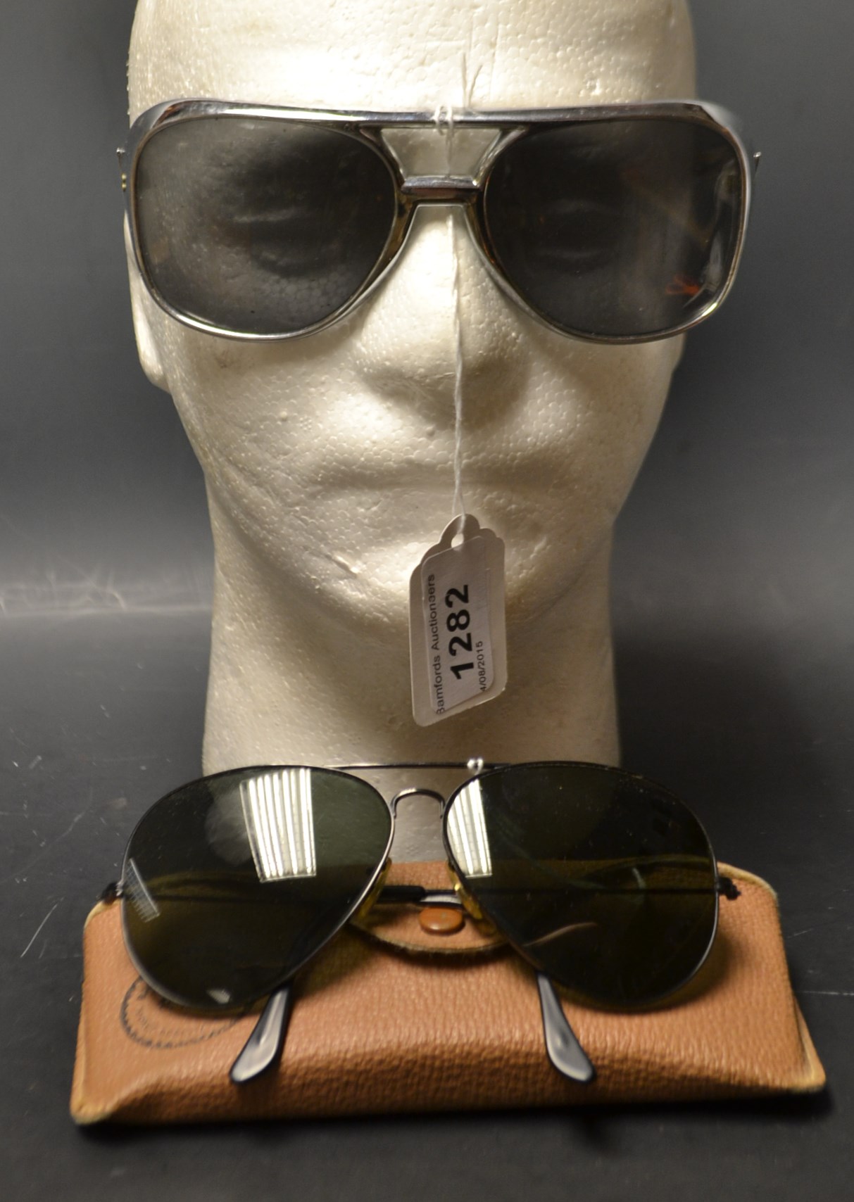 A pair of Ray-Ban designer sunglasses with case and original receipt;