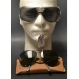 A pair of Ray-Ban designer sunglasses with case and original receipt;