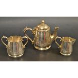 An Early 20th century white metal three piece tea service, tapering conical body,