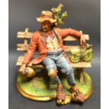 A Capodimonte figure, signed Vopla, Tramp on a bench,