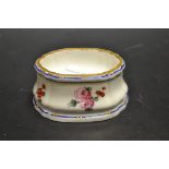 A Sevres shaped oval salt cellar, painted with rose sprigs, blue and gilt line border, 7cm wide,